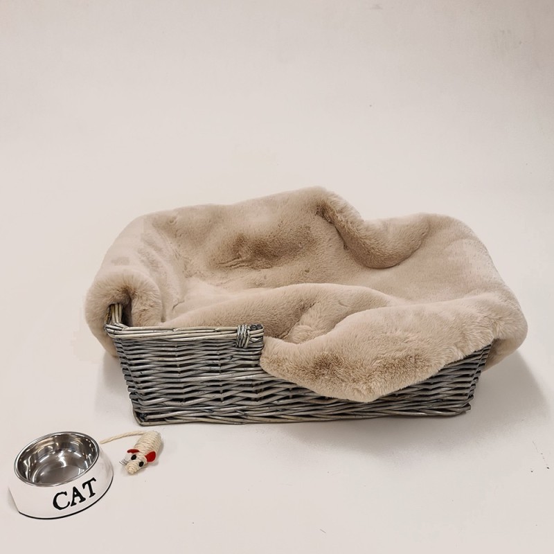 Chelsea Sandstone faux fur dog blanket lining a grey wicker basket